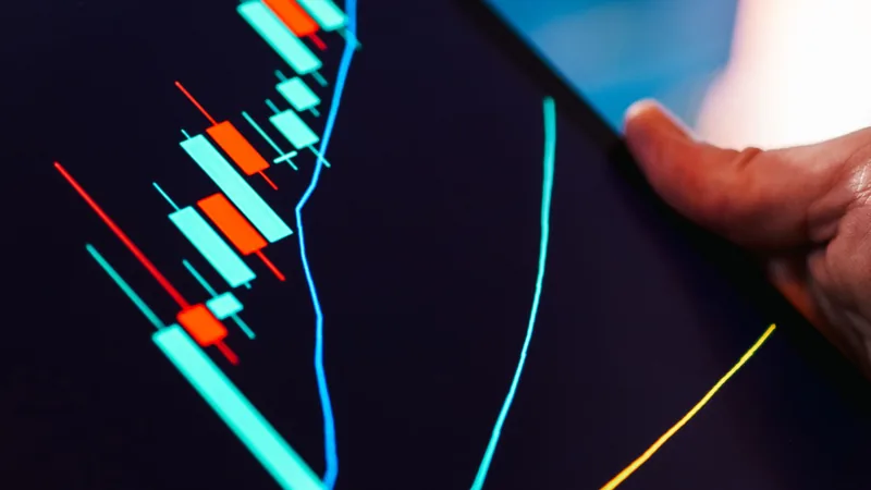 A tablet displays an analytics chart, representing predictive AI and lead-scoring email automation.
