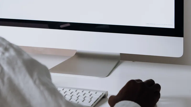 A person reviews email campaigns on a desktop computer, representing AI-powered email marketing automation.